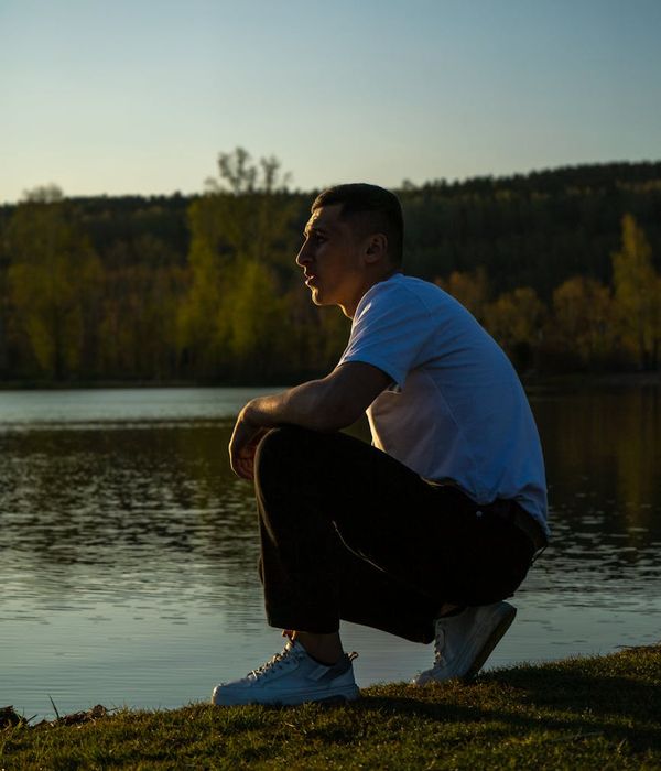 Silhouette of a man meditating against a dawn sky, representing clarity of mind.